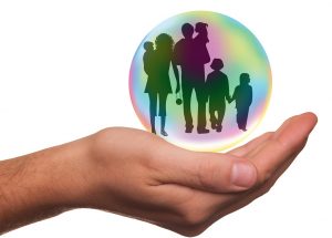 family safe in a bubble held by a hand